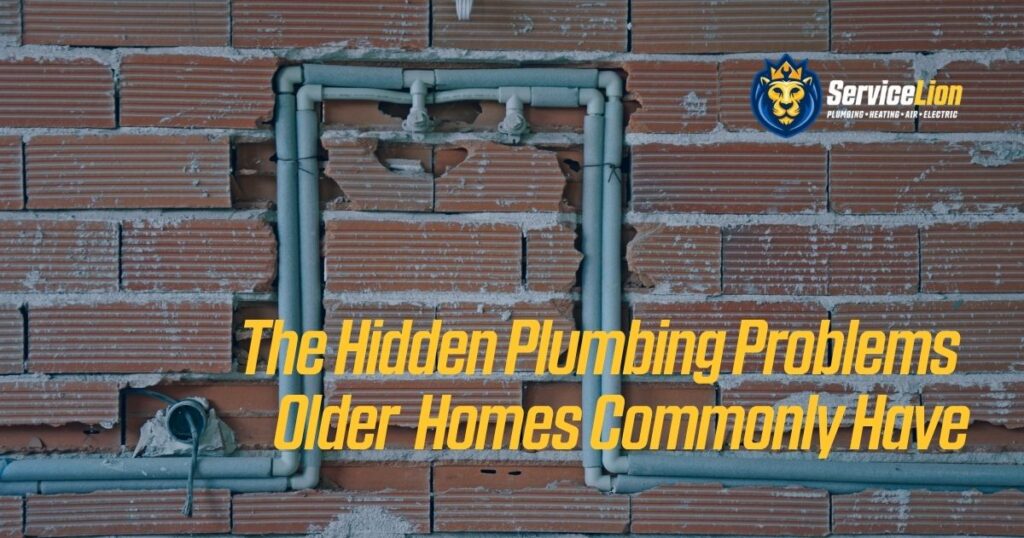 Exposed old plumbing pipes set in a brick wall with cracks and damage. Text reads: "The Hidden Plumbing Problems Older Homes Commonly Have in Yorba Linda." Service Lion logo in top right corner.