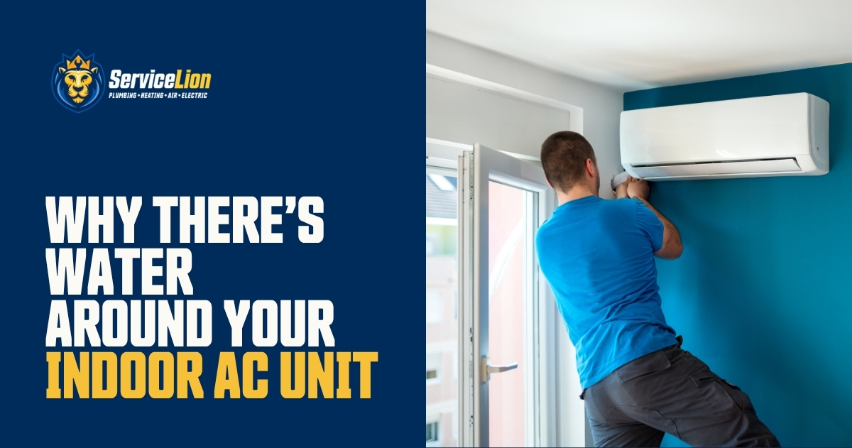 A technician inspects an indoor air conditioning unit mounted on a blue wall near a window, carefully checking for any signs of an AC unit leak or indoor AC water issues.